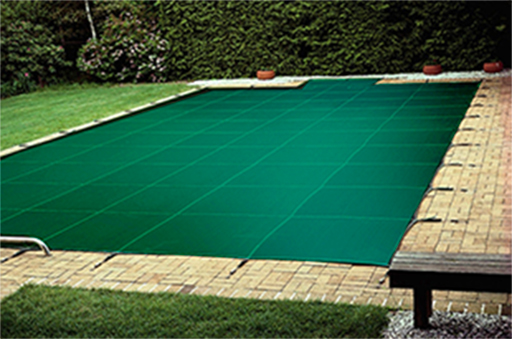 Pool accessories covered in a green tarp.